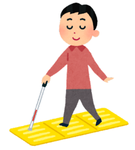 点字ブロックの上を歩く白杖ユーザー